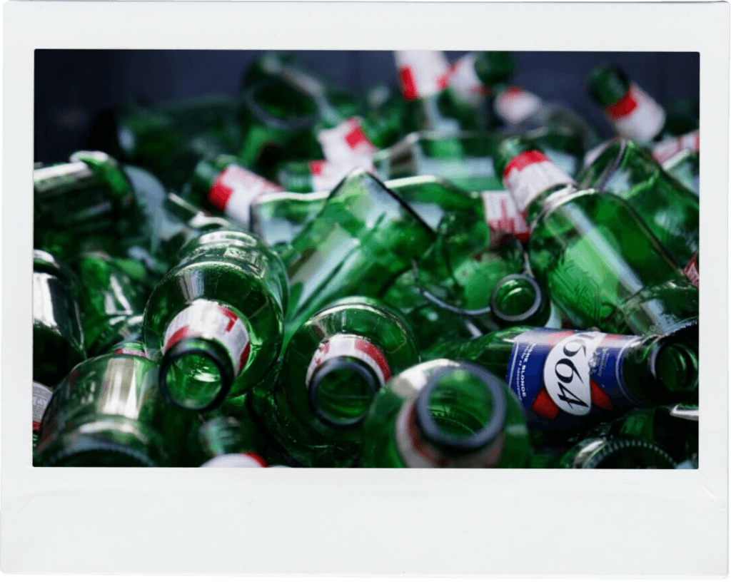 Discarded green glass bottles ready for waste collection