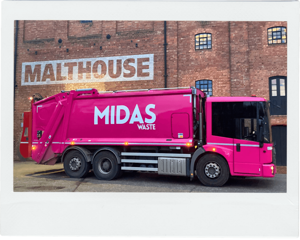 A Midas Waste dustcart set against the red brick walls of the Malthouse Theatre in Canterbury