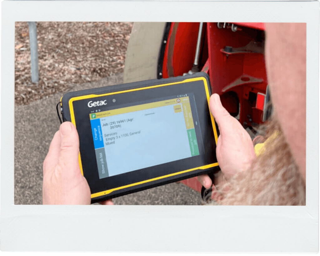 A Midas Waste driver using a tablet to view waste collection information through PurGo