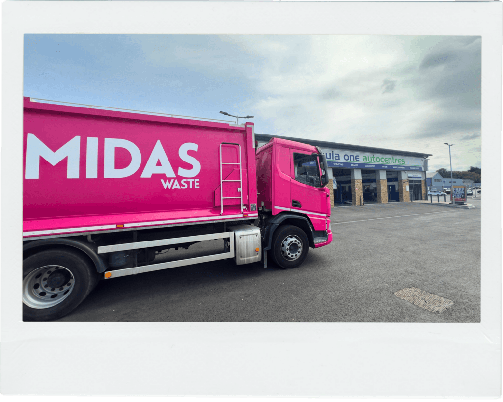 A Midas Waste dustcart parked outside an automotive shop in Canterbury, Kent