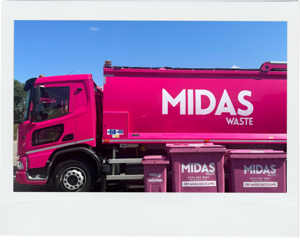 A Midas Waste dustcart sits behind three Midas Waste wheelie bins at an industrial site in Kent