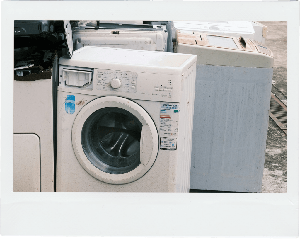 Discarded washing machines and large appliances stacked together