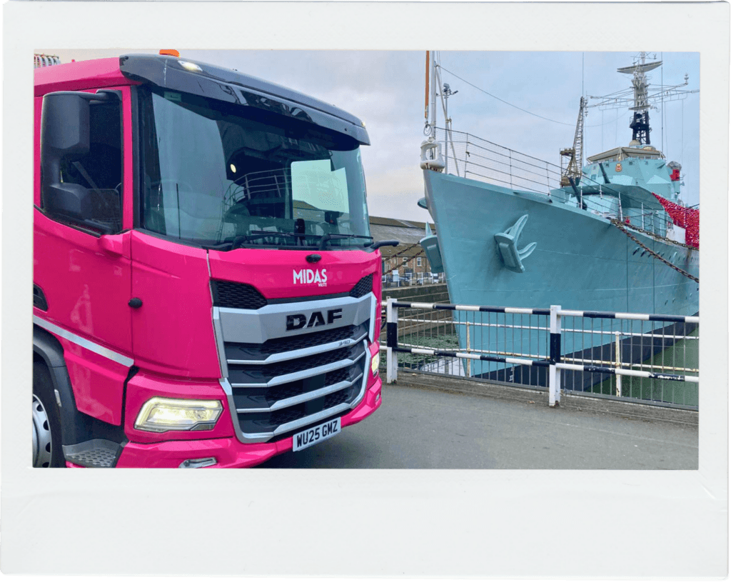 A Midas Waste dustcart vehicle in front of a ship at the Historic Dockyard Chatham, Kent
