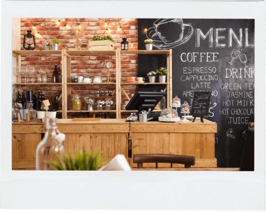 The interior of a cosy coffee shop in Thanet, Kent, featuring exposed brick and a chalkboard menu on the wall